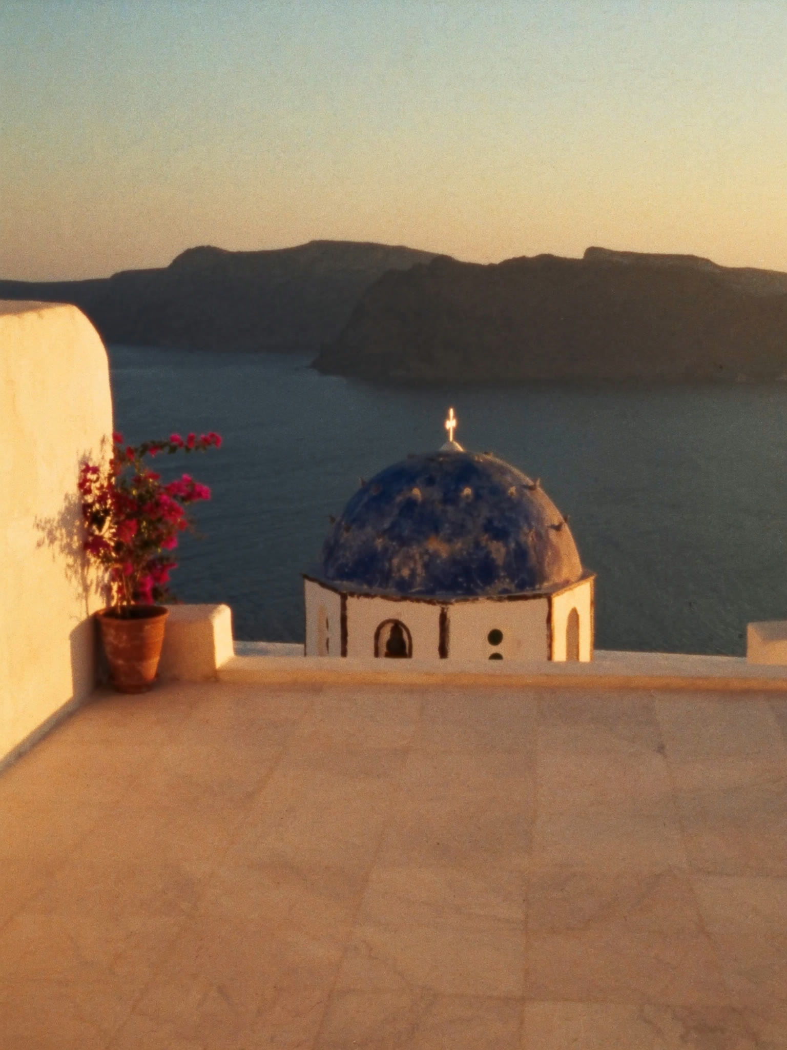 Golden hour over the caldera from a cliffside terrace in Oia